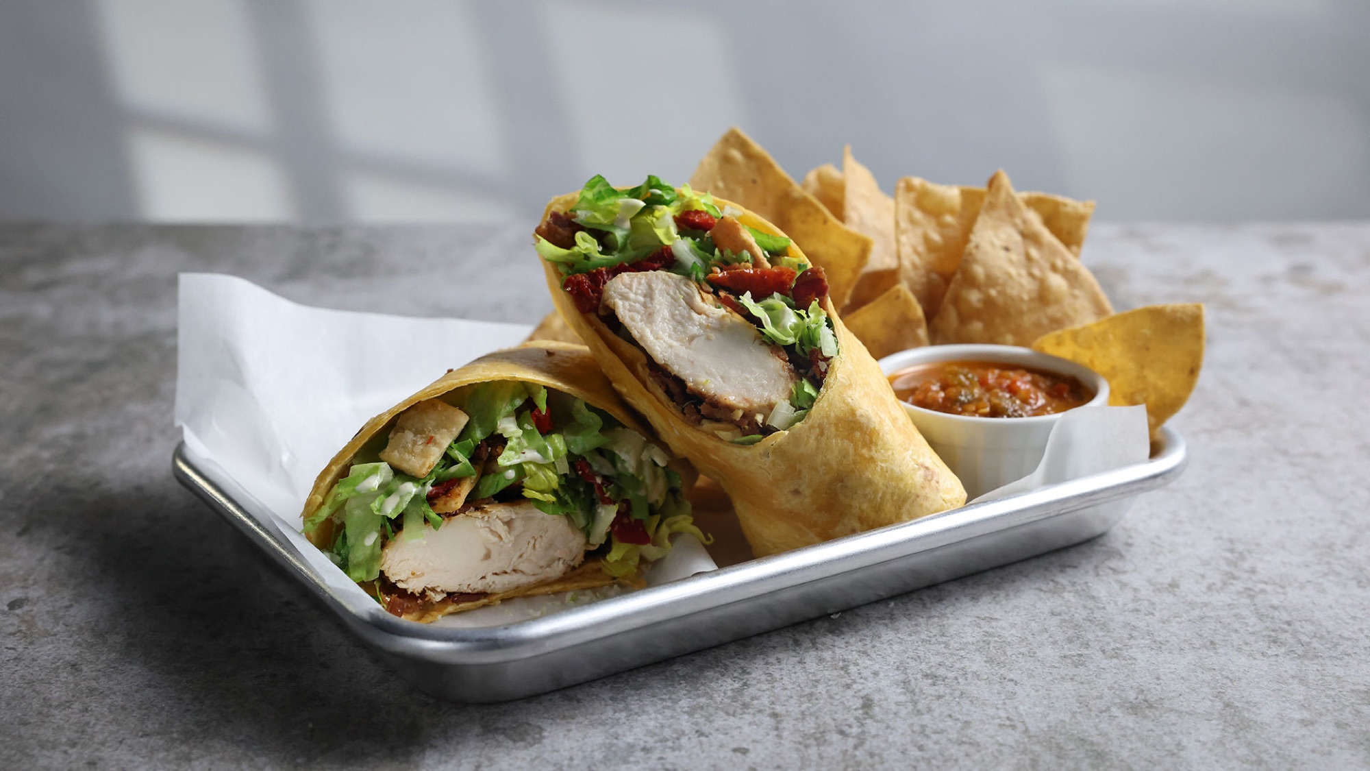 Chicken Caesar wrap with chips and salsa