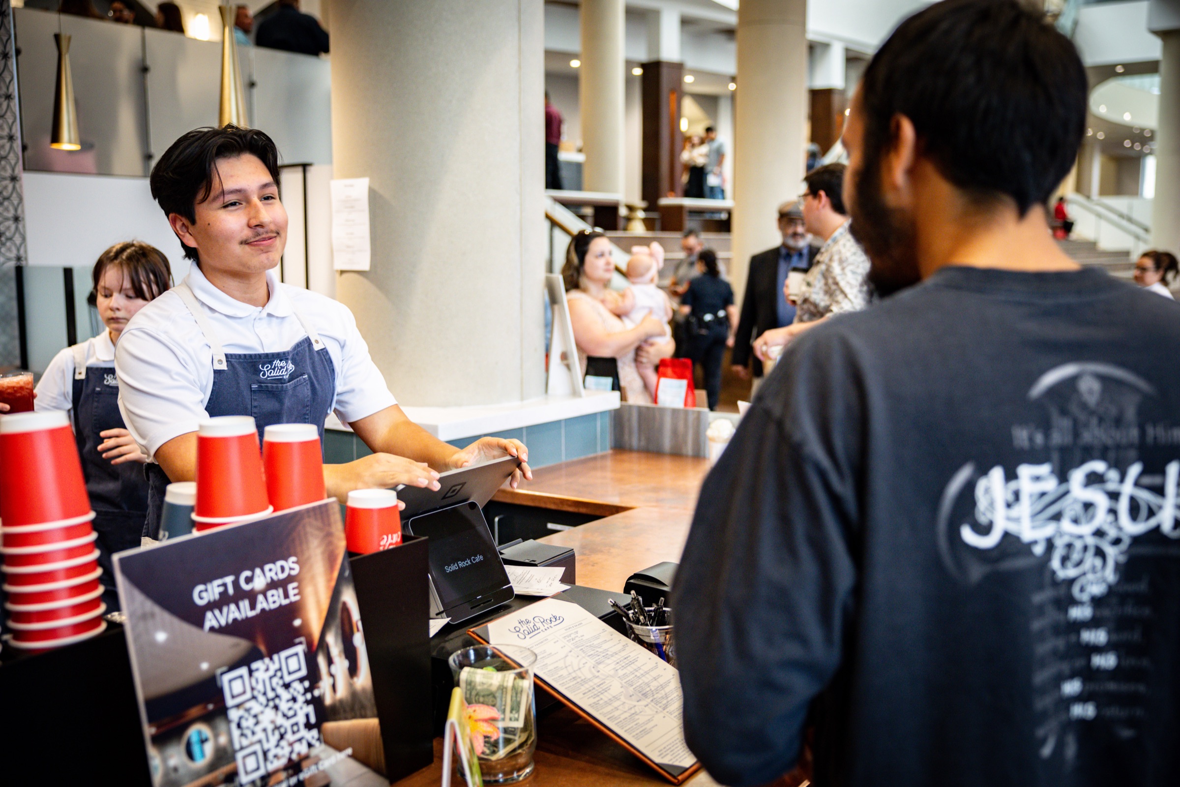 A barista at the Solid Rock Café counter