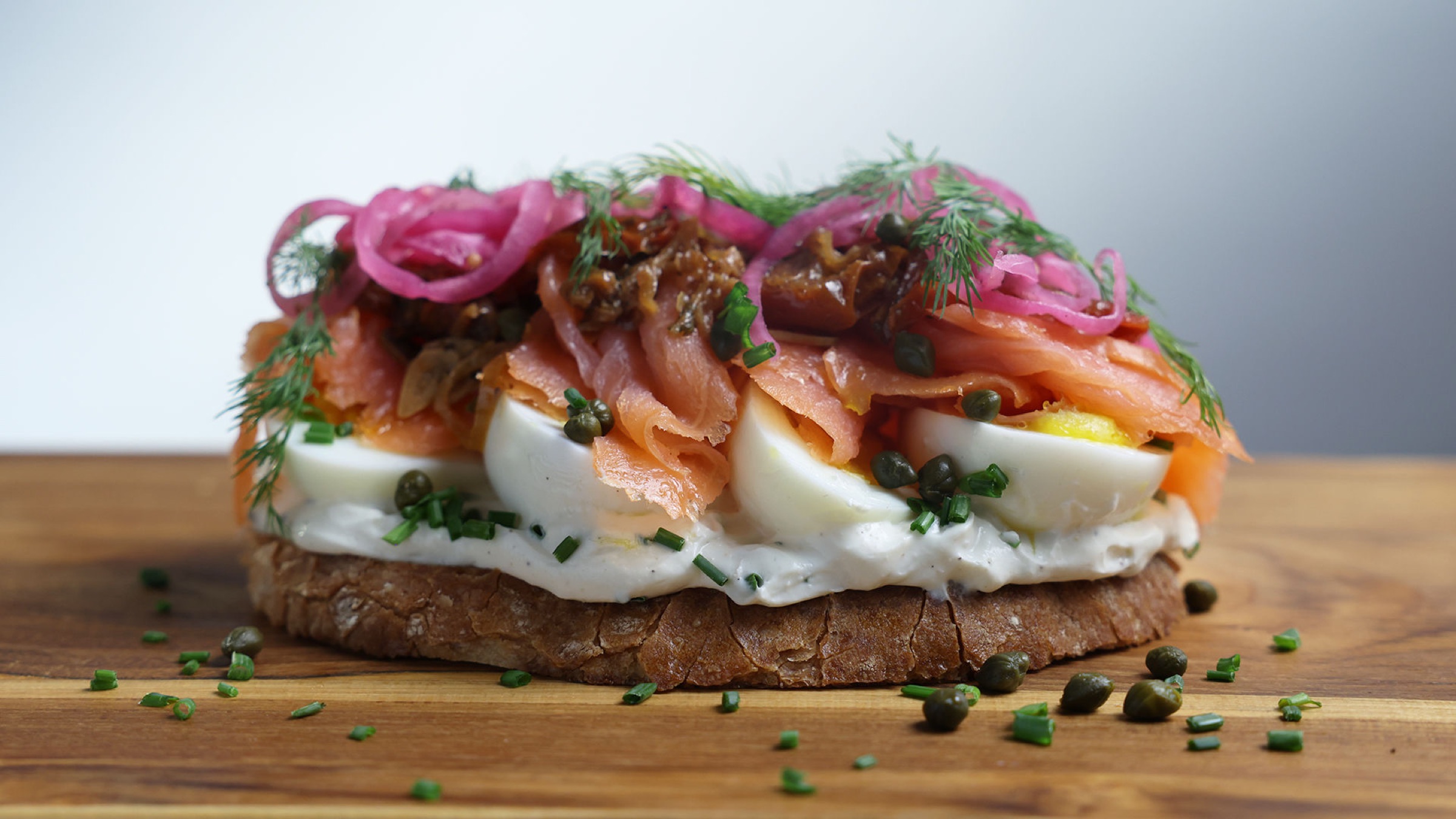 Smoked salmon tartine with egg, pickled onion, dill and capers