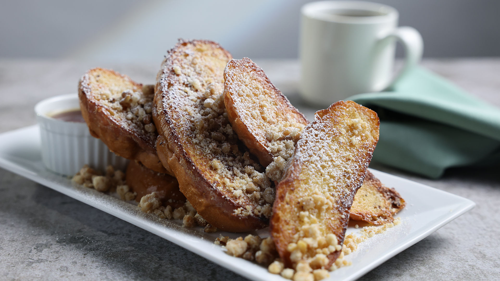 Piloncillo French toast with pecan streusel, powdered sugar and syrup