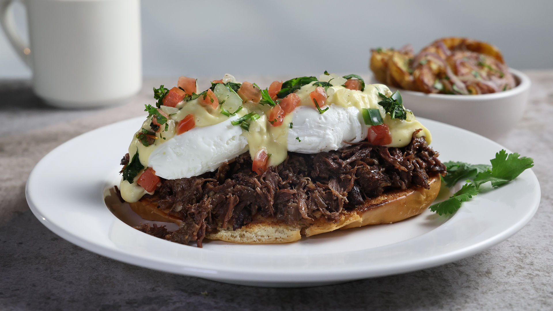 Tex-Mex Benedict with shredded beef, poached eggs, hollandaise and pico de gallo