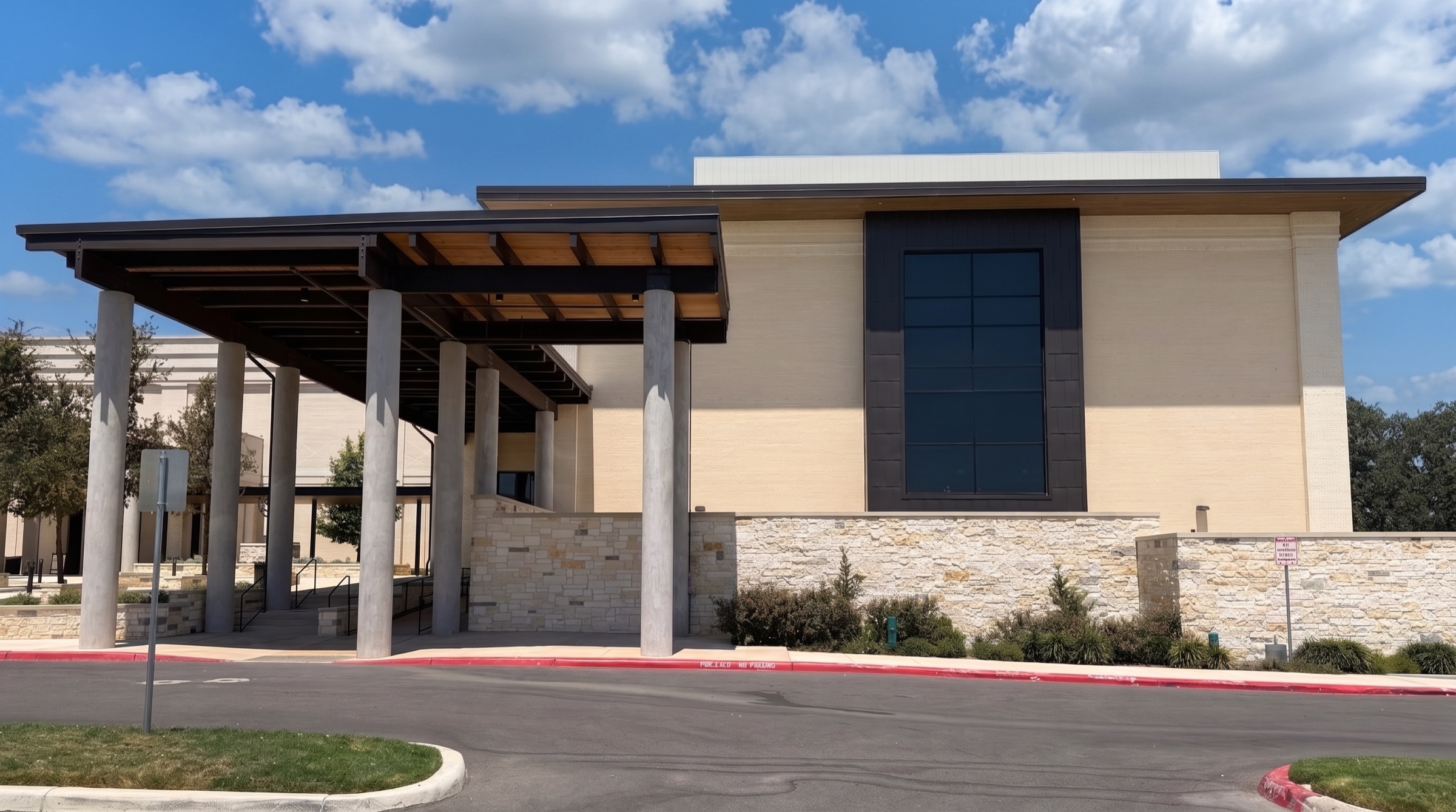 The café building in Stone Oak, with stone, brick and a covered entrance